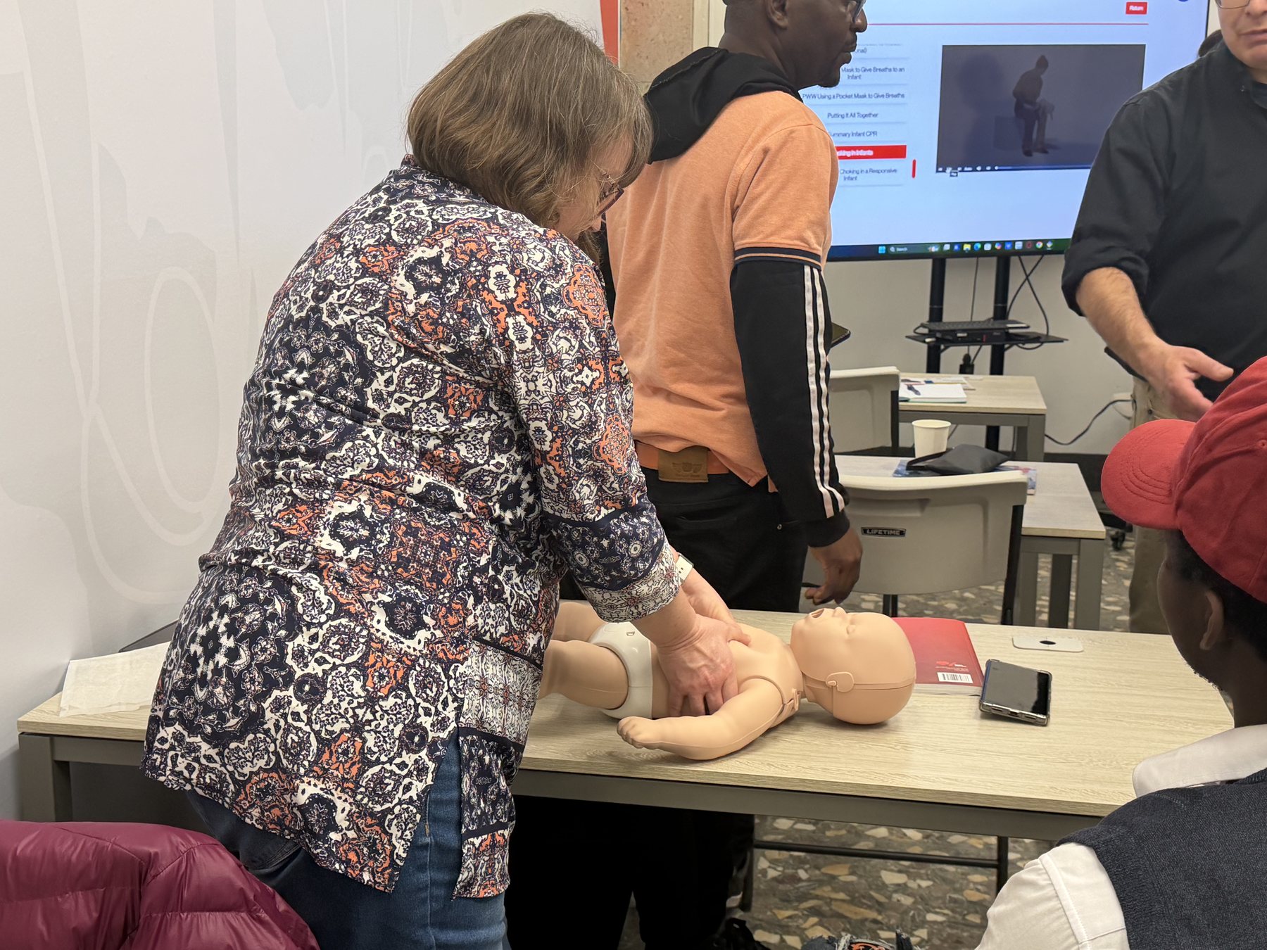 Two participants practising CPR together